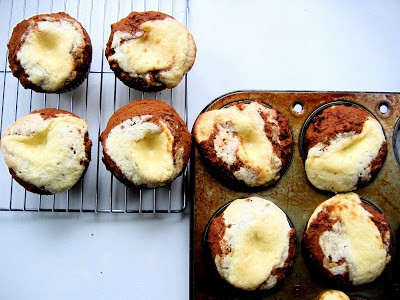 top down shot of pumpkin cheesecake muffins on a wire rack