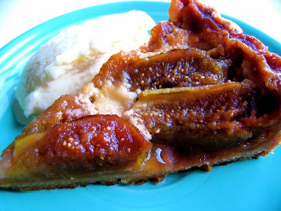 a slice of fig custard tart on a plate 
