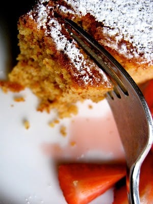 fork slicing through almond cake