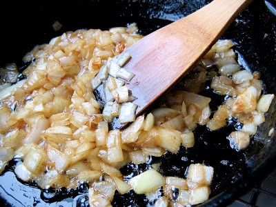 chopped onions in a pan being cooked