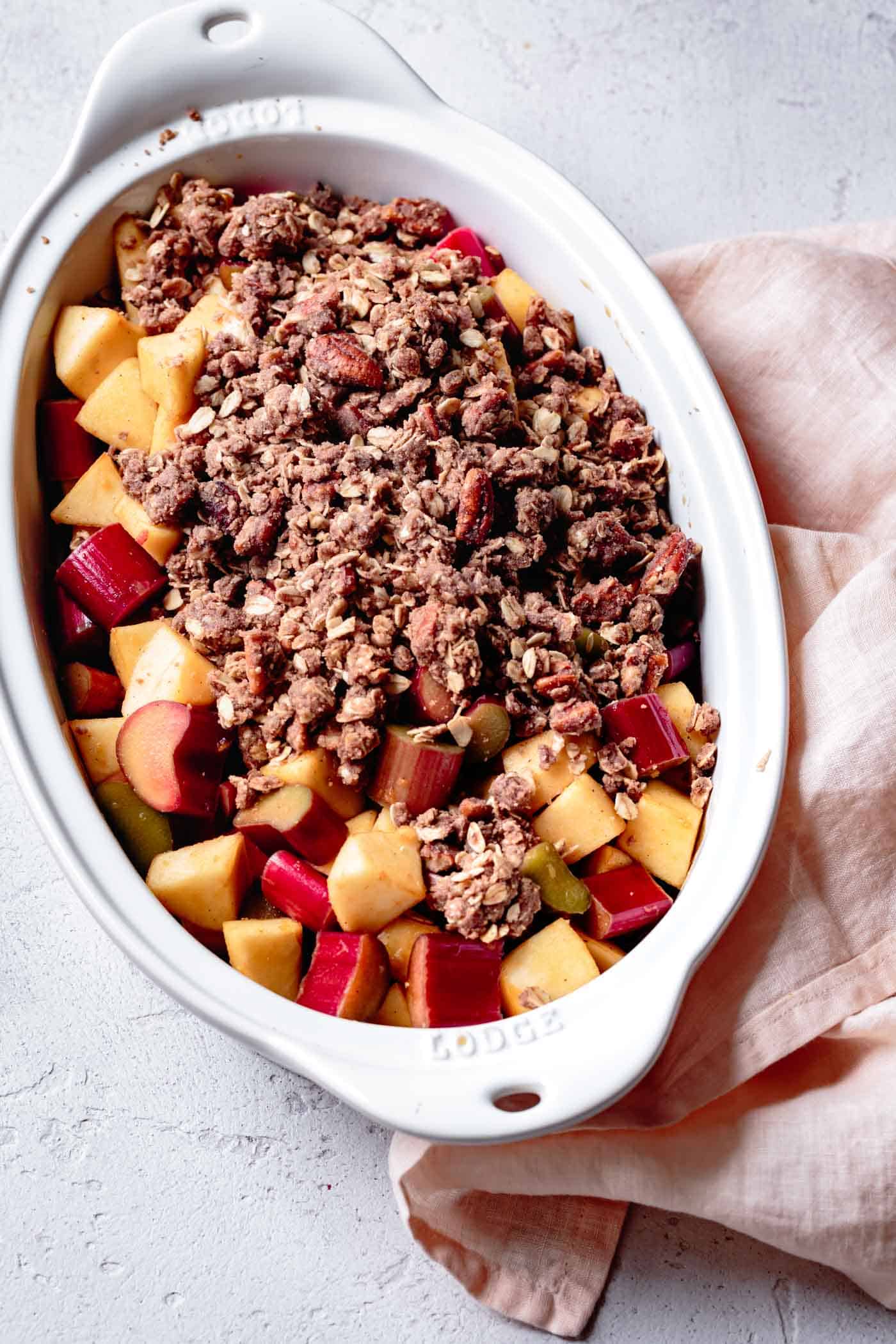 unbaked apple rhubarb crisp with oatmeal in a baking dish