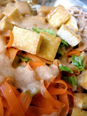 close up of tofu and shredded carrots