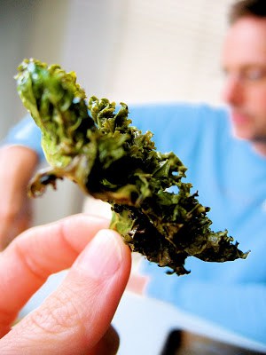hand grasping a kale chip 
