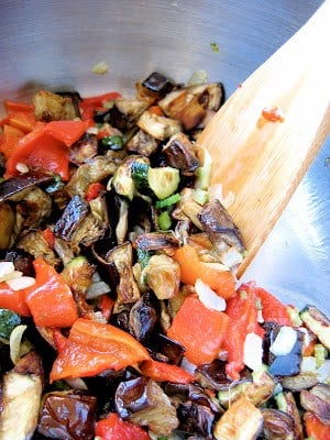 peppers being stirred in a pot