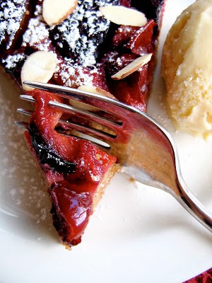 fork cutting through plum tart