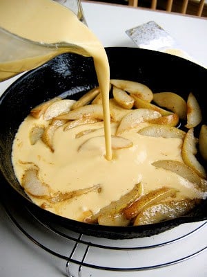 batter being poured over pears