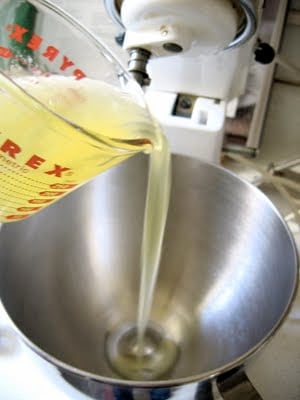 wet ingredients being poured into a bowl 