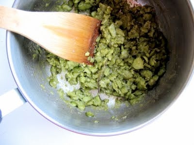 fava beans in a pot being stirred 