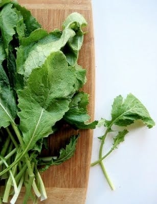 turnip greens on a chopping board