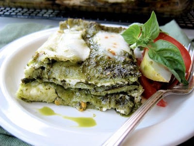 slice of zucchini pesto lasagna on a plate with fork 