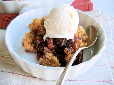 plum crumble in a bowl with ice cream 