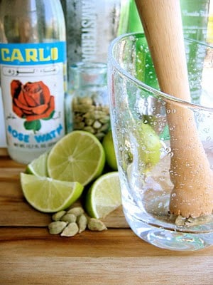 cardamom being muddled in a glass 
