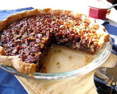pecan pie with slice taken out 