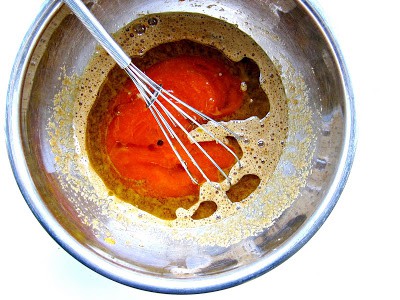 wet ingredients in a bowl being whisked 