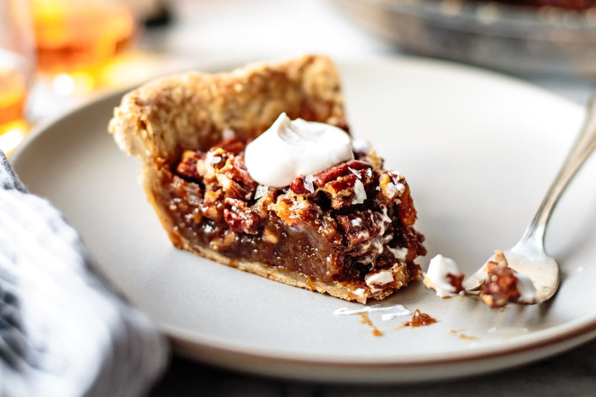 a slice of pie on a plate has a bite taken out