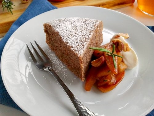slice of brown butter cake on a plate with a fork 