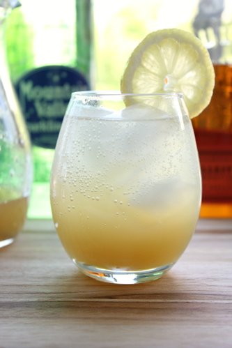 whiskey cocktail in a glass with a slice of lemon 