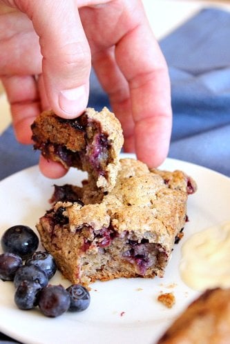 hand breaking up scone