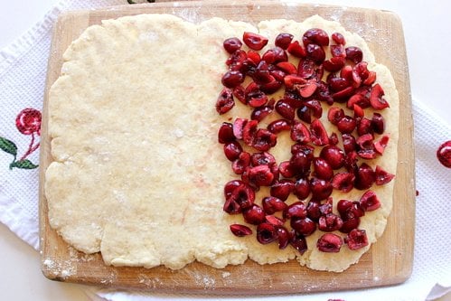 sheet of pastry with cherries on it