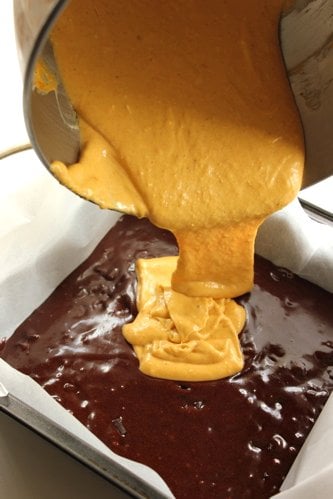 brownie mix being poured into a baking tray 