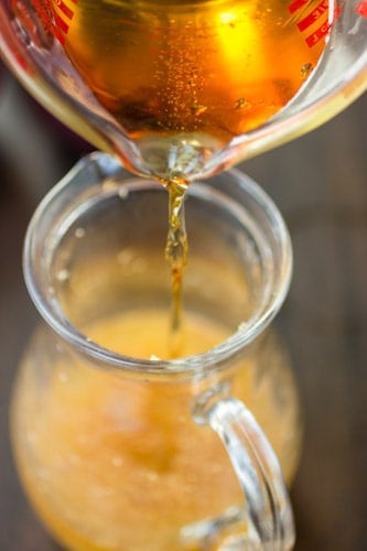 whiskey poured into jug 