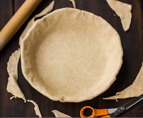crust being cut to size 