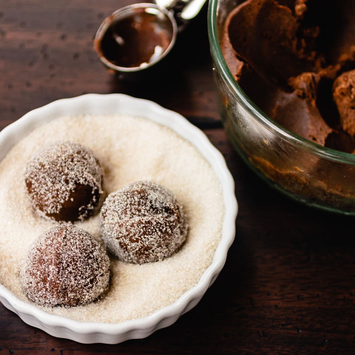 dough balls have been scooped and rolled in sugar