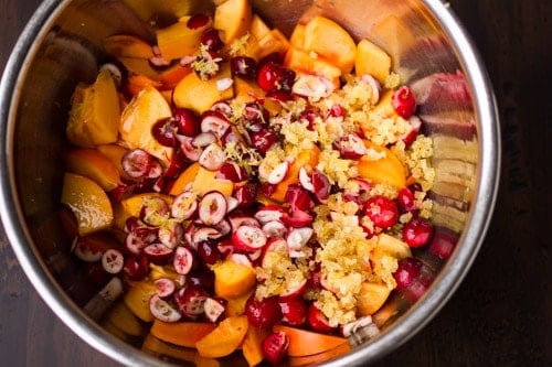 cranberries and persimmons in a bowl 