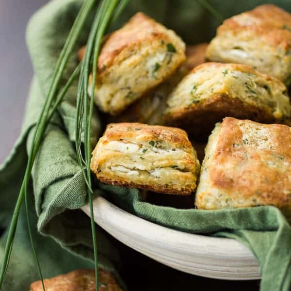 a bowl full of cheese and chive biscuits 