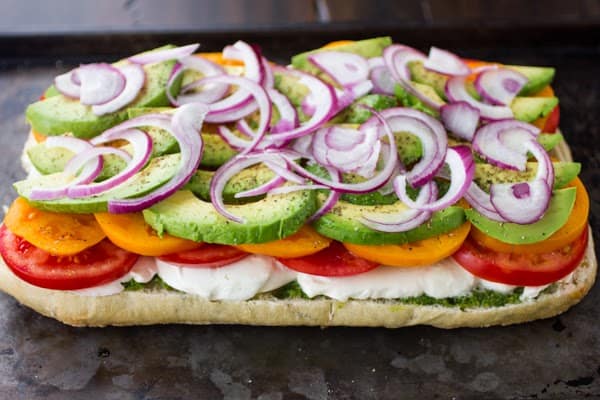 layers of vegetables on bread slice 