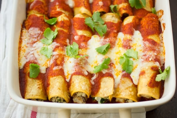 Kale and Cauliflower Enchiladas with Potatoes, Shiitakes, and Goat Cheese in a baking tray