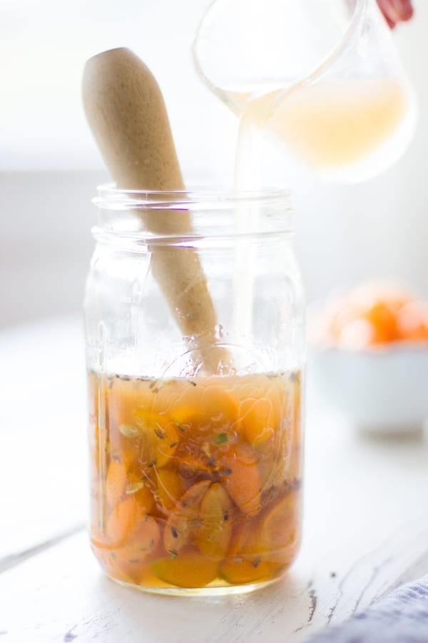 fruit being stirred in jar