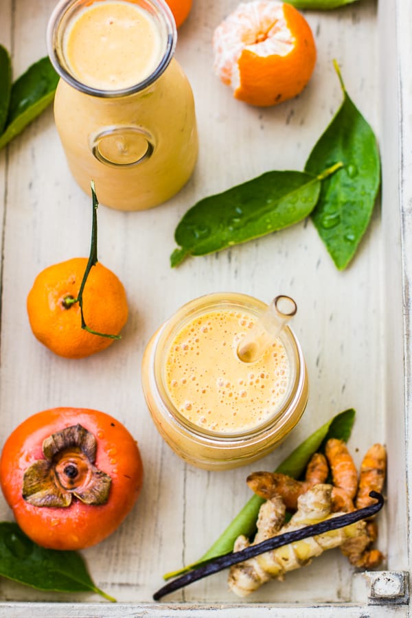 Persimmon and Tangerine Smoothie with Vanilla, Ginger and Turmeric on table