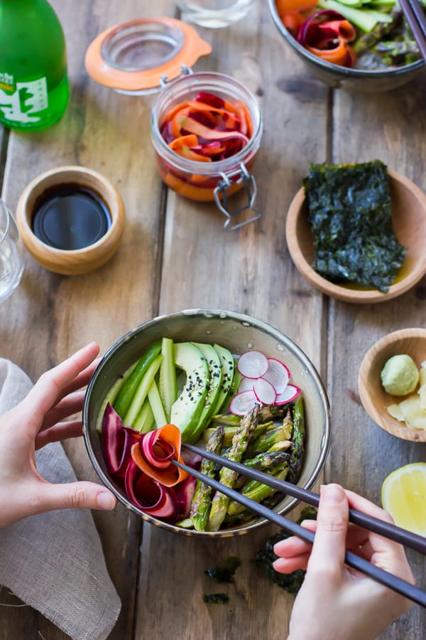 Vegan Sushi Bowls with Miso-Roasted Asparagus and Pickled Carrot on a table