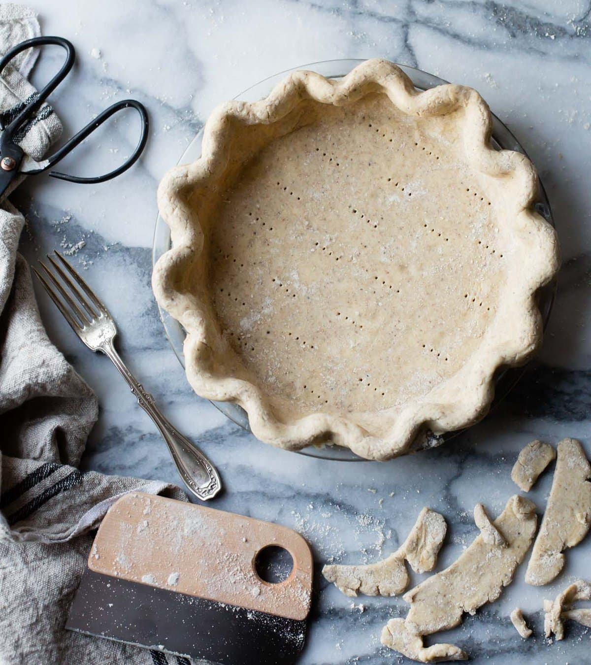 the finished unbaked pie crust, docked with a fork