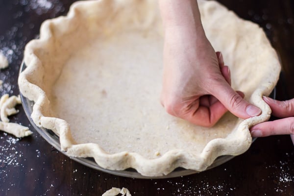 Flaky Gluten-Free Pie Crust (Whole-Grain + Gum-Free) being pressed into pan