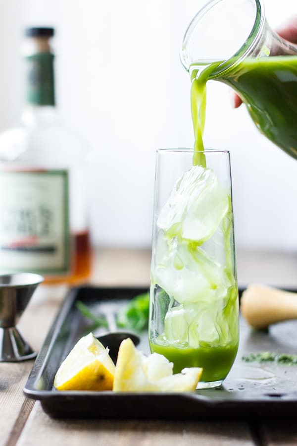 matcha cocktail being poured over ice
