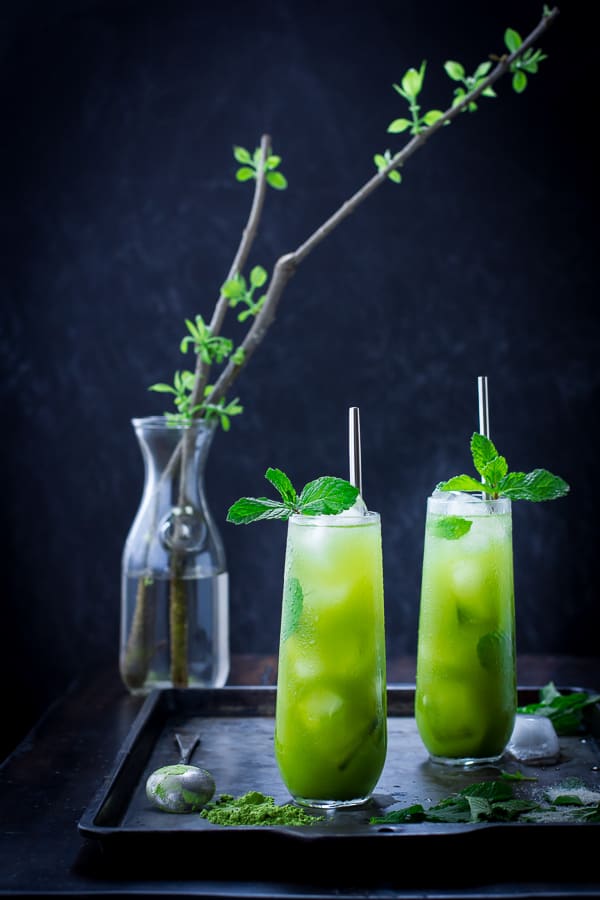 two matcha cocktails on a dark tray