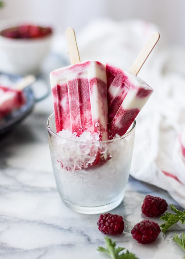 Tayberry, Rose Geranium + Buttermilk Popsicles in a glass 