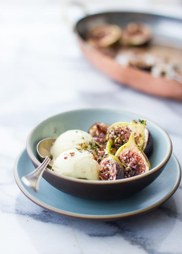 side shot of bowl of Za'atar Broiled Figs with Pecans + Goat Cheese Honey Ice Cream