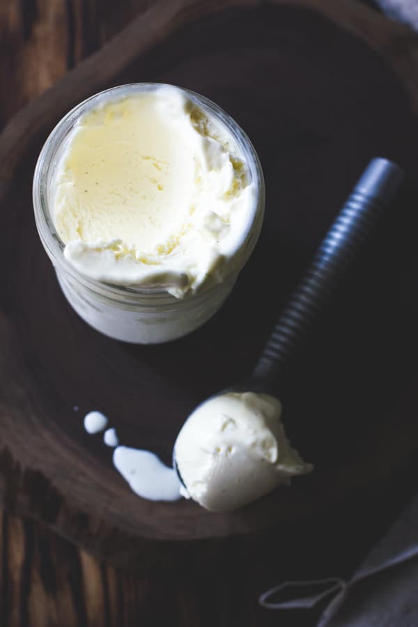 buttermilk ice cream in a jar with a drippy scoop taken out