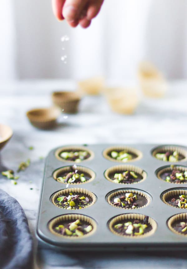 baking tray of Raw Chocolate + Pistachio Butter Cups 