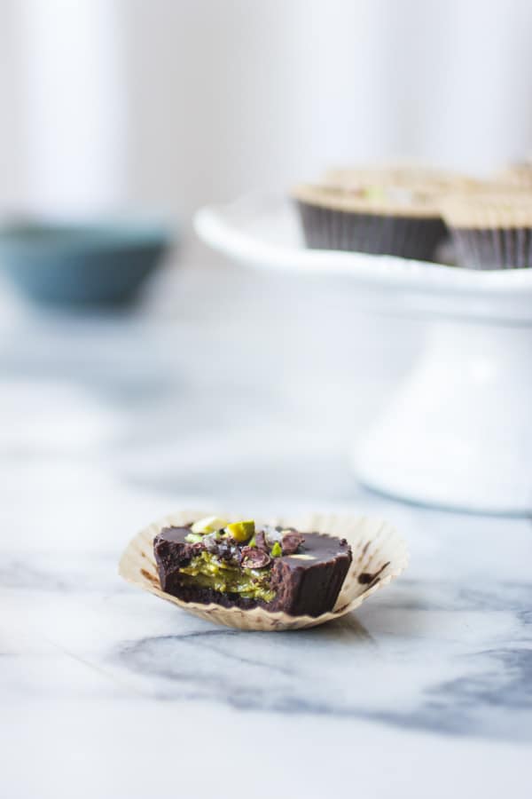 Raw Chocolate + Pistachio Butter Cups with bite taken out