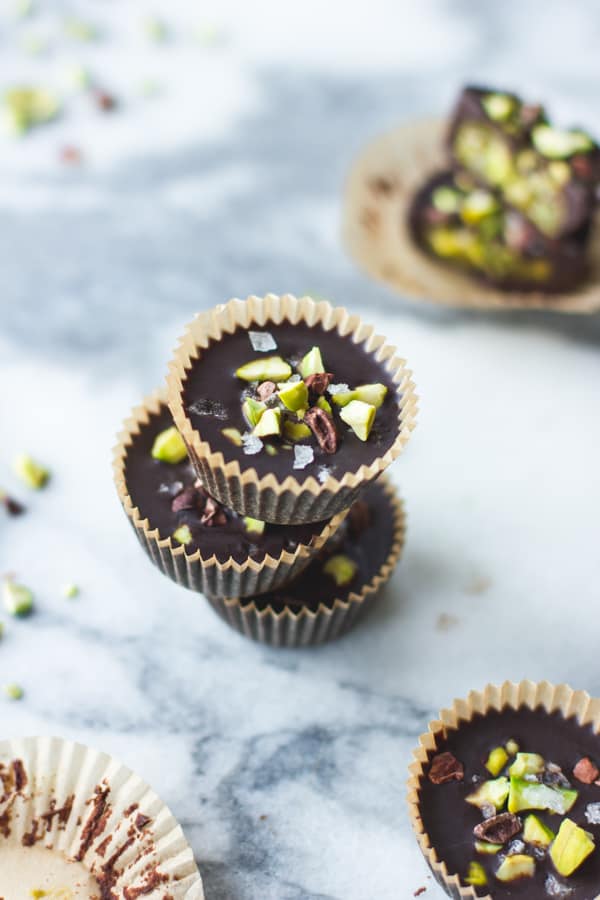 stack of Raw Chocolate + Pistachio Butter Cups