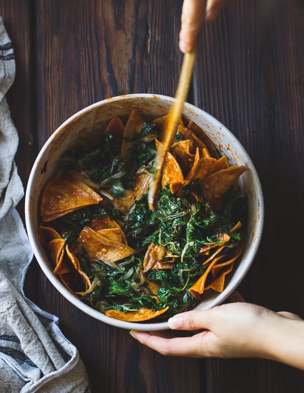 kale being mixed with chips