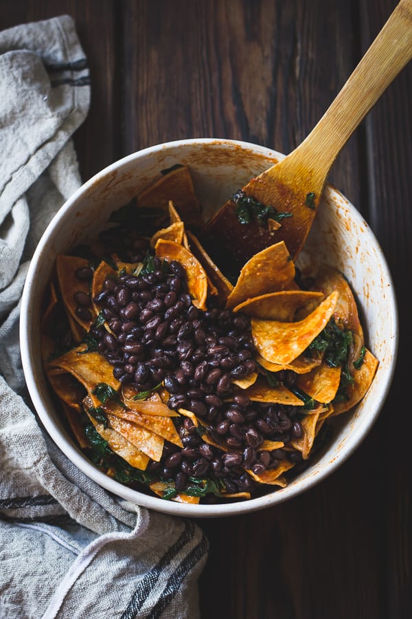 Baked Chilaquiles with Black Beans and Kale mixed in bowl