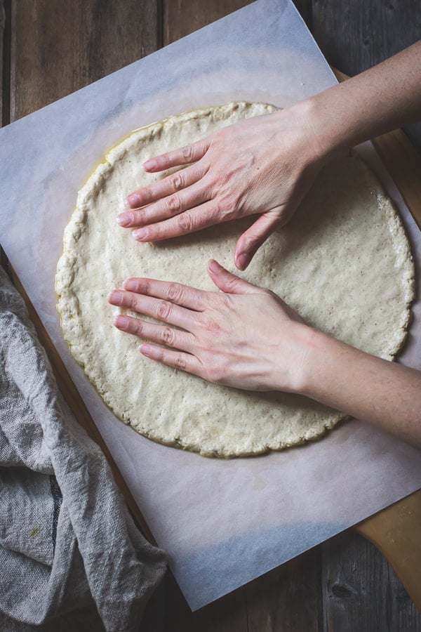 hands flattening Gluten-Free Pizza Crust