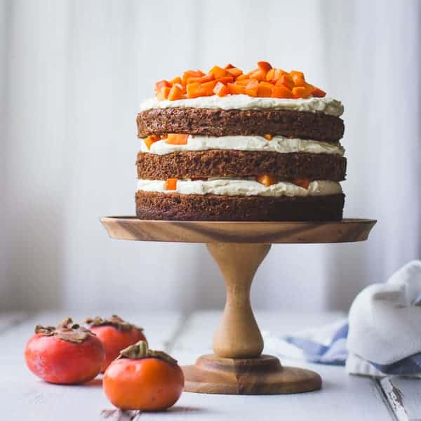 Two-Persimmon Layer Cake with Vanilla Bourbon Cream Cheese Frosting on stand