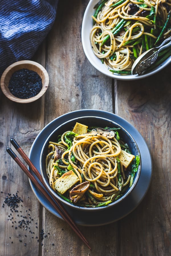 Hot Sesame Rice Noodles with Asparagus, Shiitakes and Pea Shoots with chopsticks