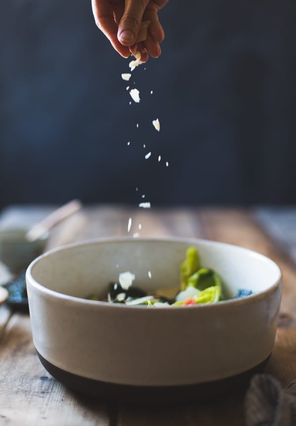 sprinkling cheese on salad